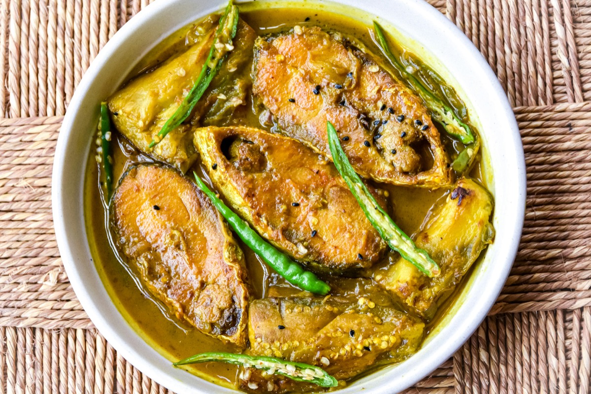 Fish steaks in a golden mustard gravy with whole green chillies